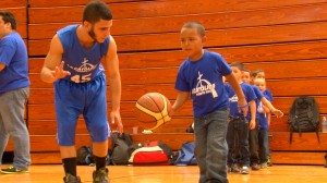 El niño de kindergarden, Jadiel Mejías practica técnicas de baloncesto con el atleta de La Católica.